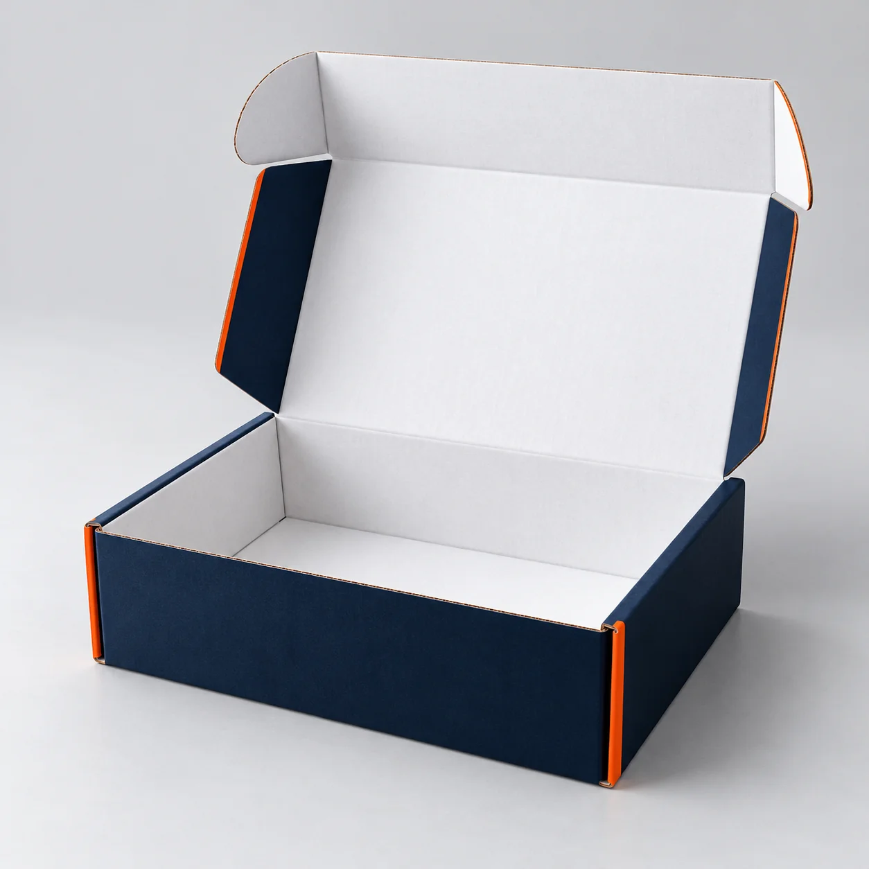 Open navy corrugated mailer box with a white interior and orange edge