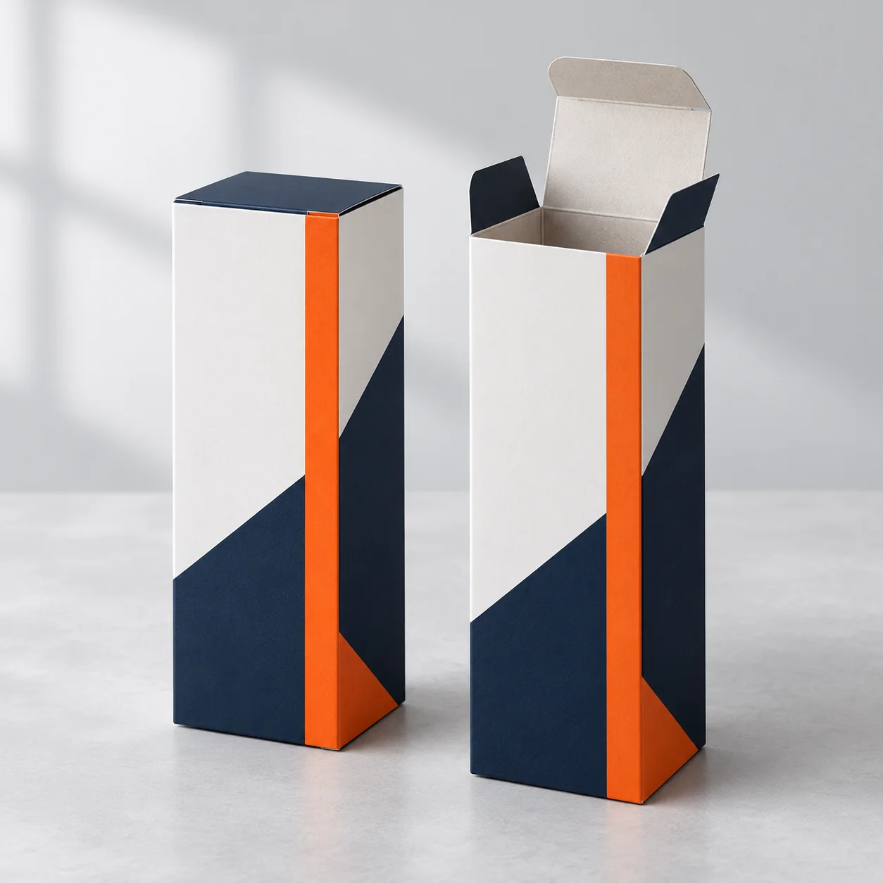 White folding retail cartons with navy panels and orange print accents