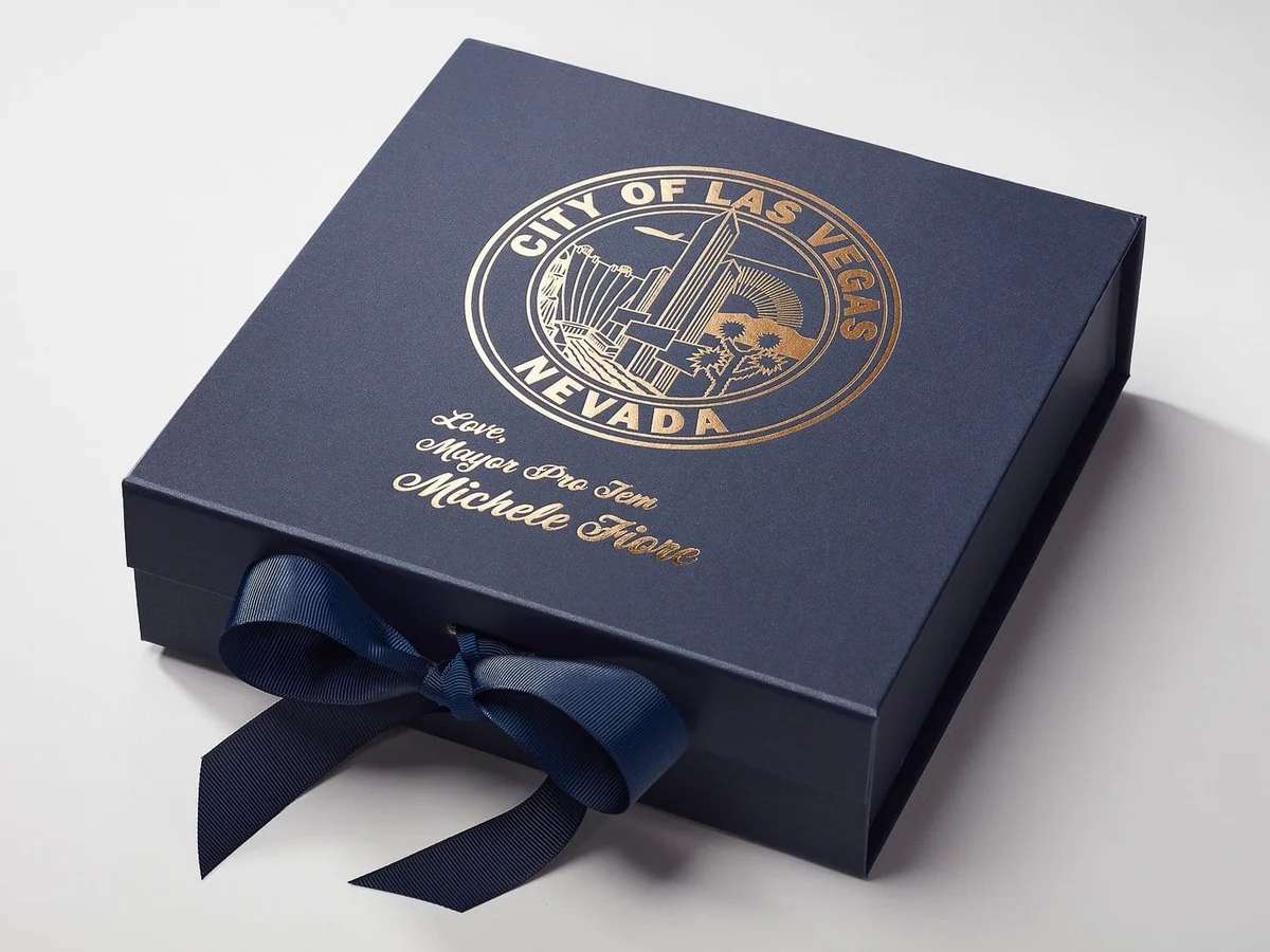 Gold foil sun motif on textured navy packaging board
